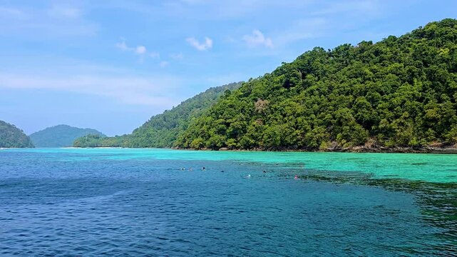 Experience the breathtaking beauty of Surin Island in Thailand, featuring turquoise waters and lush greenery. Discover the rich marine life while swimming and snorkeling in this tropical paradise.