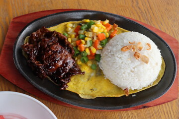 black hotplate rice vegetable fish chicken and meat  dinner with slice fruit
