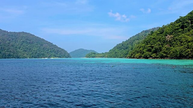 Explore the breathtaking landscapes of Surin Island in Thailand, where crystal clear waters meet green hills. Experience the serenity and natural wonders that this tropical paradise has to offer.