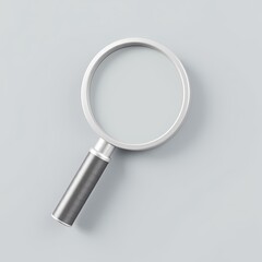 A magnifying glass is on top of a grey surface.