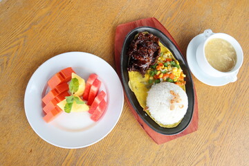 black hotplate rice vegetable fish chicken and meat  dinner with slice fruit