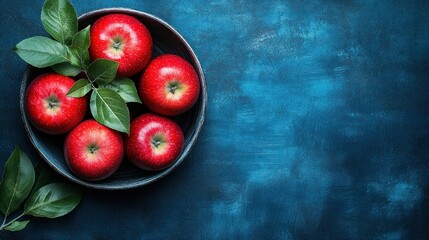Five Red Apples in a Dark Bowl on a Blue Background