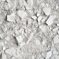 A textured surface of crushed light gray material with various sizes of irregular fragments scattered throughout.