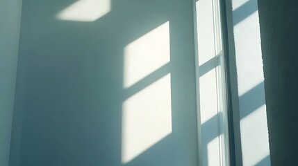Fototapeta premium Sunlight casts window shadows on a wall