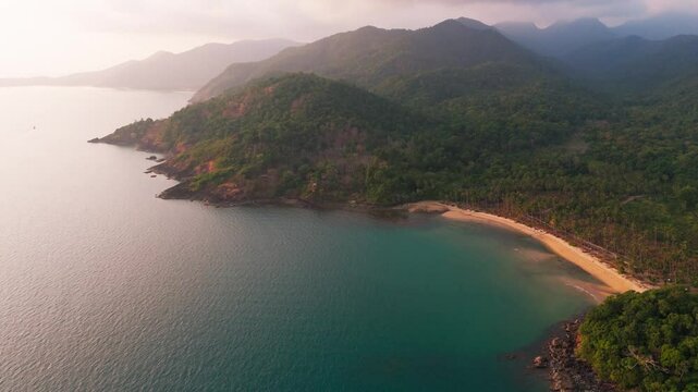 Aerial hing angle of Koh Chang island in Thailand drone fly above scenic lonely tropical secluded beach paradise at sunset