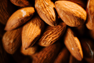 Enjoying crunchy almonds on a plate against a sleek black background for a classic snack experience