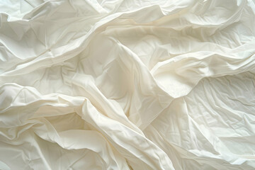Soft, crumpled white fabric draped elegantly, creating a serene atmosphere for photography or design