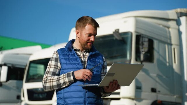 Supervisor giving loading instructions via radio at truck parking