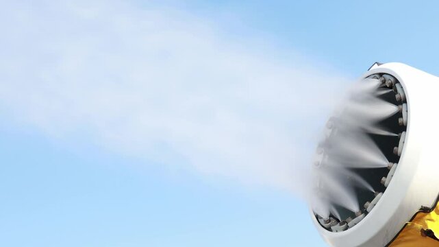 Experience cutting-edge winter technology with a fan snow cannon efficiently producing artificial snow. This automated machine enhances resort conditions sustainably, creating winter joy