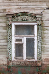 Window of an old wooden house with carved frames