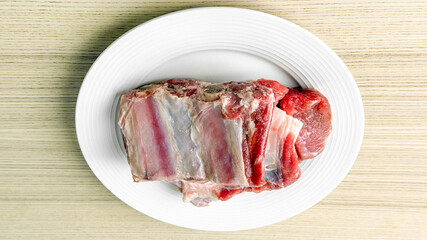 Raw lamb rack on white plate, fresh meat cooking preparation, culinary cuisine ingredients, food photography