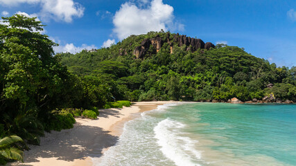 Bay with soft waves lapping on a sandy beach. Anse Louis. Seychelles, Mahe. © Alex Traveler
