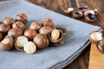 Macadamia nuts on a wooden table. Macadamia is a superfood.