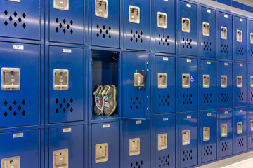 Empty team locker, locker room, changing room with traditional blue metal lockers.