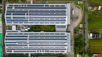 A vast factory rooftop is covered with solar panels, harnessing renewable energy for a greener and...