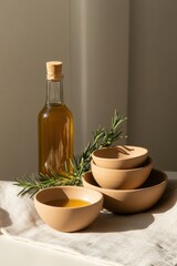 Elegant arrangement of ceramic bowls, olive oil bottle, and fres