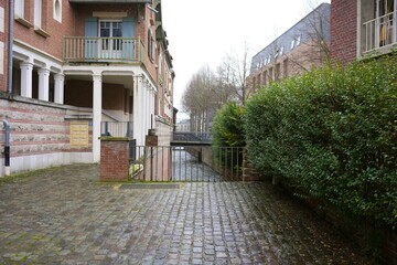 Cobblestone path with canal view in Amiens, France