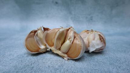 a few heads of garlic isolated on a grey background