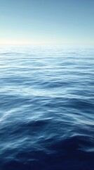 Obraz premium Calm ocean surface reflecting the clear blue sky, creating a serene and tranquil atmosphere