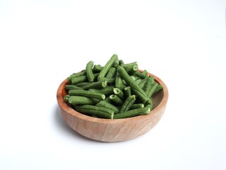 Yardlong bean or kacang panjang on a wooden bowl isolated white background.