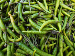 Chili is a spicy, flavorful pepper used to enhance taste and add heat to dishes. Chili display in market place for sale, colorful picture for social media