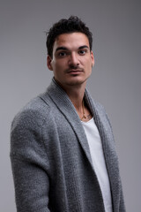 Portrait of a serious young man wearing a cardigan