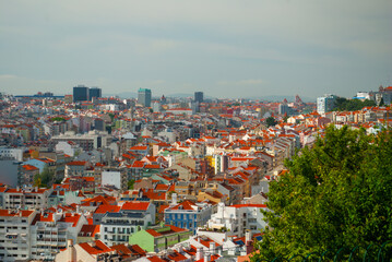 A stunning panoramic view of Lisbon, Portugal, showcasing its iconic red rooftops, modern and historic architecture