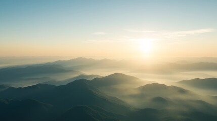 Fototapeta premium Serene misty mountains at sunrise with soft golden light, creating a peaceful and dreamy atmosphere, perfect for nature and tranquility concepts