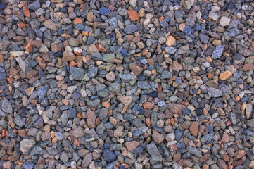 Colorful assortment of small stones and gravel in a natural setting showcasing various textures and hues