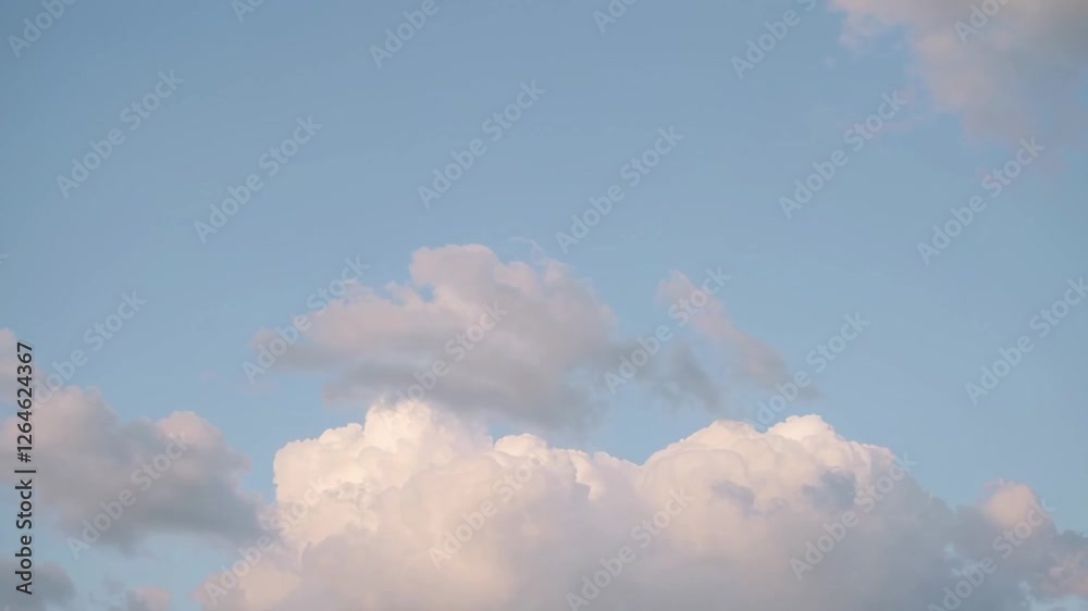 Poster pristine white cumulus clouds drifting and morphing against vibrant blue sky backdrop, creating sere