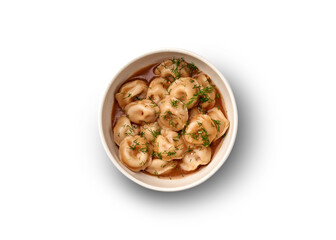 A bowl of traditional pelmeni dumplings served in a rich broth with fresh dill.