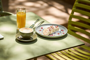 A delicious and colorful breakfast of syrniki pancakes served with fresh berries, a cup of coffee,...