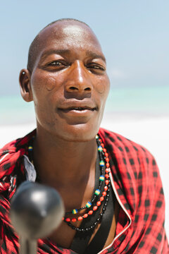 Male masai with face scarifications and ear holes.