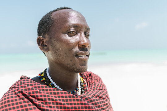 Male masai with face scarifications and ear holes.