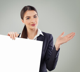 Fototapeta premium Confident business woman holding white empty paper banner background with copy space indoor