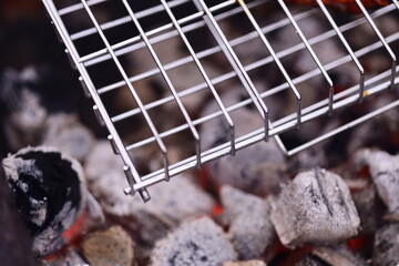 Grilled hot dogs on a grill grate, ready to eat.