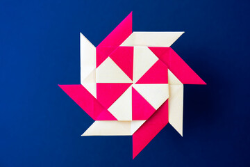 Close-up of origami abstract wind rose paper figure against black background. Photo taken February 14th, 2025, Zurich, Switzerland.