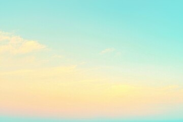 Fototapeta premium A tranquil pastel sky with soft hues of blue, yellow, and pink, adorned with delicate clouds, creating a dreamy and peaceful atmospheric backdrop.