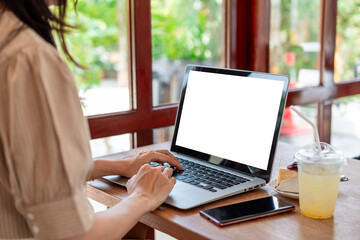 Fototapeta premium Young Asian woman with drinks working with laptop in cafe, Digital nomad lifestyle