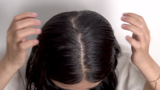 woman massaging scalp with hands, hair care treatment concept, 4K footages