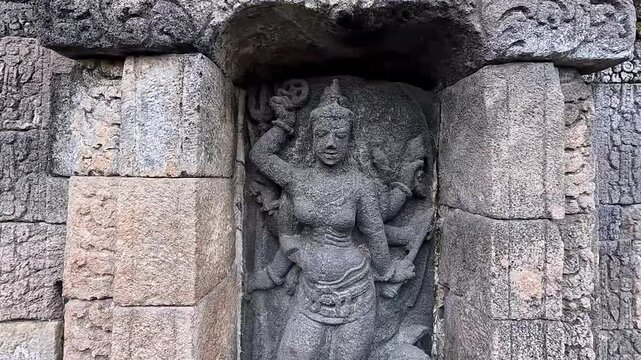 Ancient stone sculpture of a man, a religious art monument in Asian temple architecture