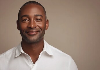 Obraz premium A mature black African man, aged 40-60, shows a calm and composed demeanor, with a warm smile that captures his thoughtful introspection and rich life experiences.