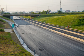 Empty Closed Highway with Fresh Layer of Asphalt and Overpass in the Background