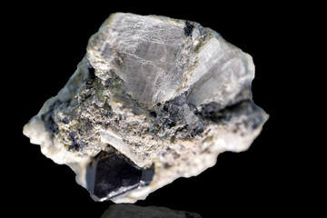 Mineral of carrollite on a black background