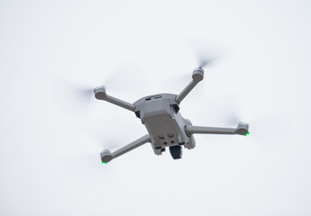 Small drone market, micro drones filming and flying above people property. Spyware of small camera recording, agile flying of nano drone
