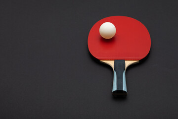 Professional Red Table Tennis Paddle with White Ball in Dramatic Studio Light