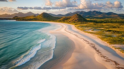 Aerial view of a pristine beach at sunset.