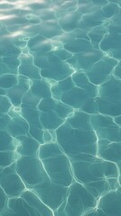 Clear turquoise water rippling under sunlight creates beautiful patterns in a serene pool environment