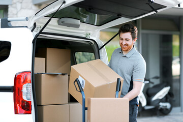 Professional delivery man loading packages on a hand truck