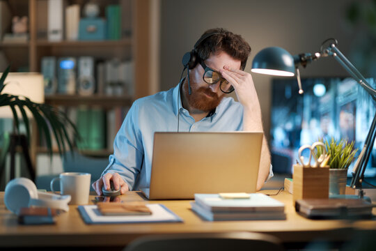 Exhausted businessman working late at night
